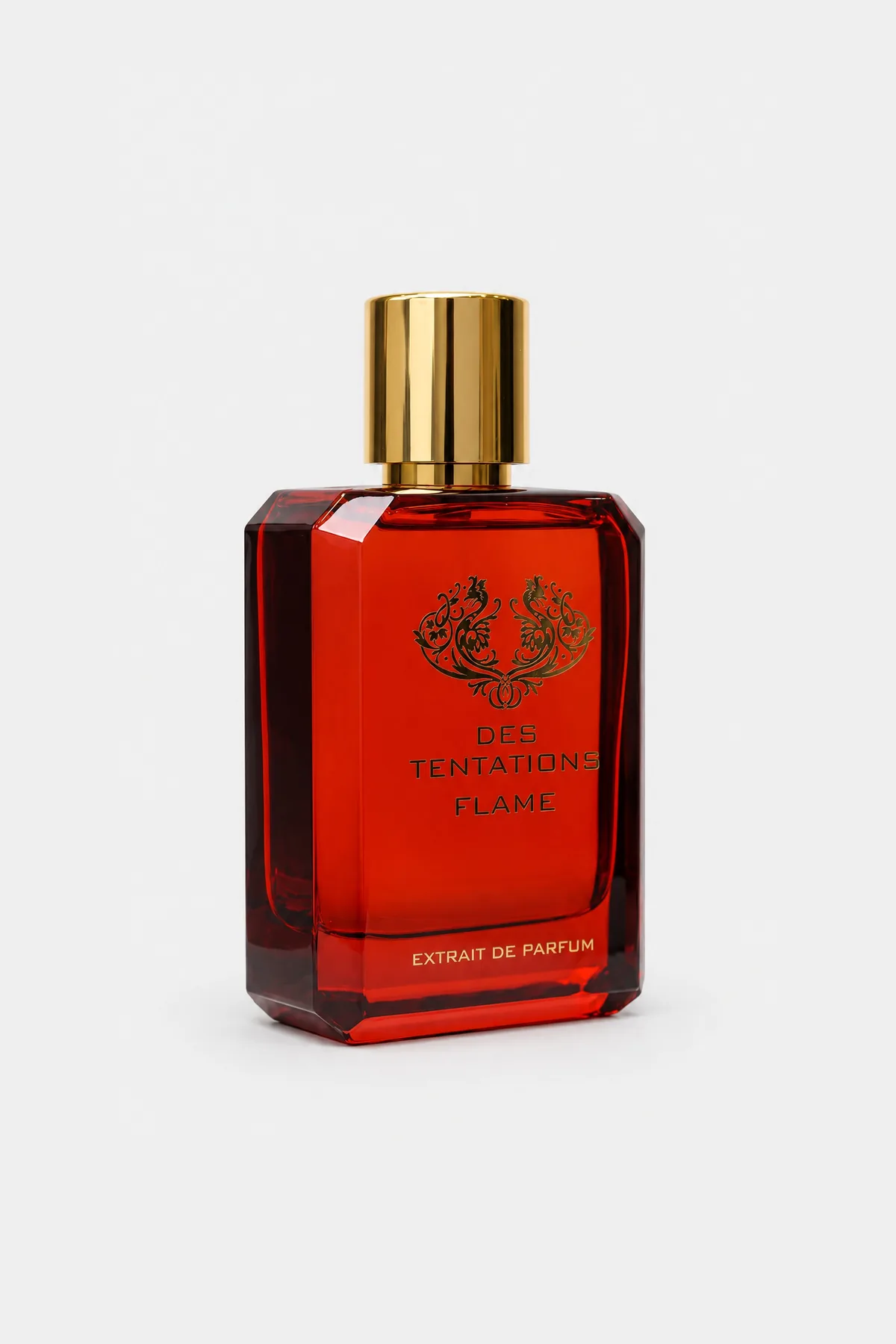 Fragrance World Des Tentations Flame Extrait de Parfum 100 ml, orange-red glass bottle with a gold cap, three-quarter view